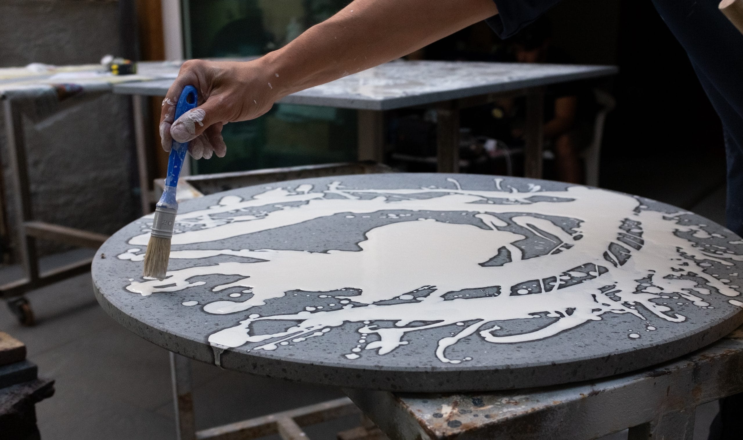 Cuore Lavico artisan hand-decorating an Etna lava stone table